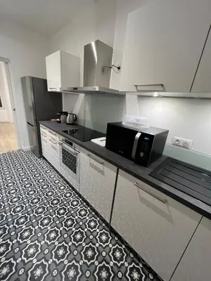 a kitchen with a microwave on a counter at AJACCIO Hyper centre Fesch in Ajaccio