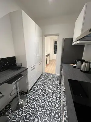 a kitchen with a black and white tile floor at AJACCIO Hyper centre Fesch in Ajaccio