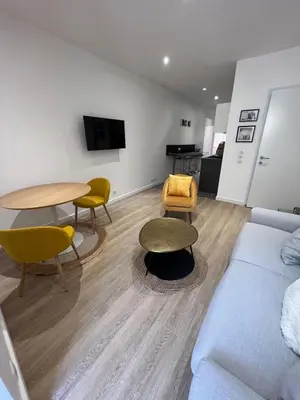 a living room with a couch and a table and chairs at AJACCIO Hyper centre Fesch in Ajaccio