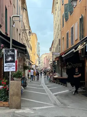 a city street with people walking down the street at AJACCIO Hyper centre Fesch in Ajaccio