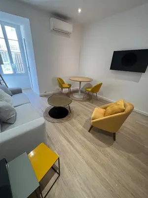 a living room with a couch and chairs and a table at AJACCIO Hyper centre Fesch in Ajaccio