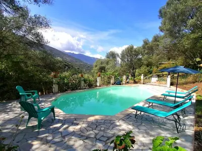 a bedroom with a large bed and a window at La licorne in Serriera
