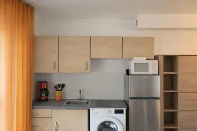 a small kitchen with a refrigerator and a microwave at Le Scudo in Ajaccio