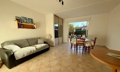 a living room with a couch and a table at Charmant Duplex proche mer, Clim Terrasse à BORGO in Borgo
