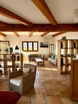 a large living room with couches and a table at Villa en pierre Vue imprenable sur le Golfe in Propriano