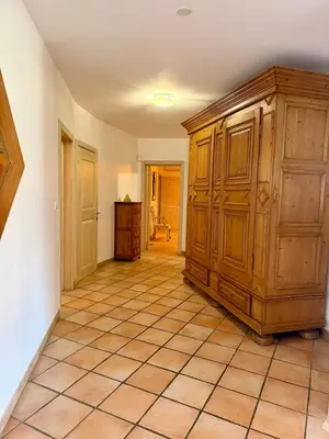 a room with a large wooden cabinet and a tile floor at Villa en pierre Vue imprenable sur le Golfe in Propriano
