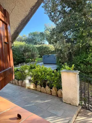 an entrance to a garden with a fence and plants at Villa en pierre Vue imprenable sur le Golfe in Propriano