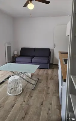 a living room with a couch and a table at Studio 2 minutes du port Bonifacio avec parking privé in Bonifacio