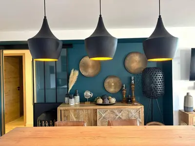 a kitchen with a table and chairs in a room at Très bel appartement à Santa Giulia in Porto-Vecchio