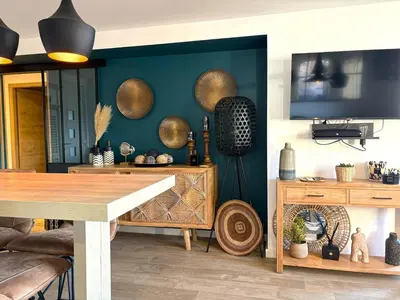 a room with wooden shelves on the wall with plants at Très bel appartement à Santa Giulia in Porto-Vecchio