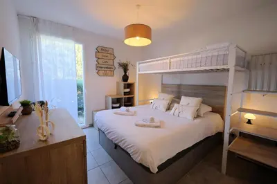 a bedroom with a bed with a bunk bed at Villa Monte Leone - 2 Piscines Bonifacio in Bonifacio