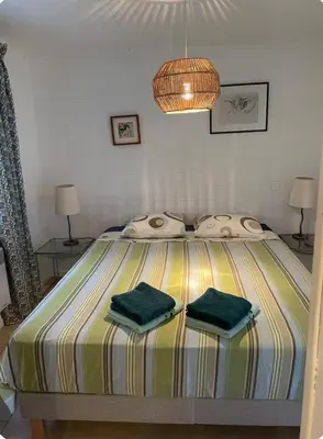 a bedroom with a bed with two green towels on it at Chioselle in Chiatra