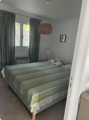 a bedroom with a bed and a window with curtains at Chioselle in Chiatra