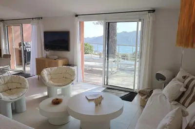 a white table and chairs with a vase of flowers at U Mulinu, Villa vue mer panoramique Santa Giulia in Porto-Vecchio