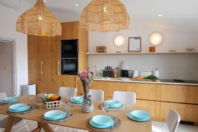 a dining room with a table and chairs at U Mulinu, Villa vue mer panoramique Santa Giulia in Porto-Vecchio