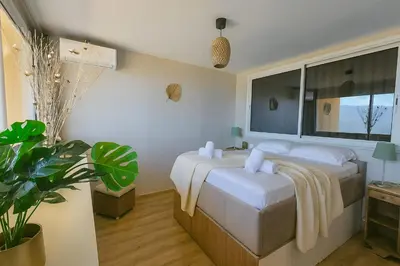 a bedroom with a bed and a large window at Sublime Appartement neuf climatisé vue imprenable sur la mer terrasse wifi in Serra-di-Ferro