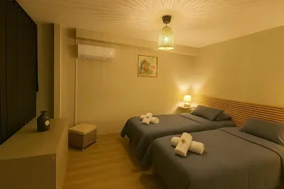 a hotel room with two beds with towels on them at Sublime Appartement neuf climatisé vue imprenable sur la mer terrasse wifi in Serra-di-Ferro