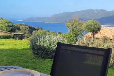 a balcony with a view of a body of water at Mini villa vue mer et wifi dans petite résidence avec piscine chauffée in Serra-di-Ferro