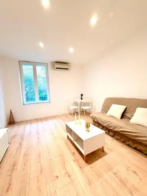 a living room with a couch and a coffee table at Appartement hyper centre 100m de la plage in Ajaccio