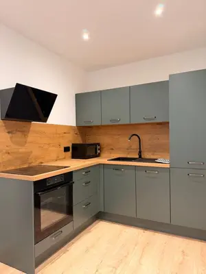 a kitchen with gray cabinets and a sink at Appartement hyper centre 100m de la plage in Ajaccio