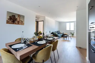 a dining room and living room with a table and chairs at Nebbiu - 25km de Bastia in Murato