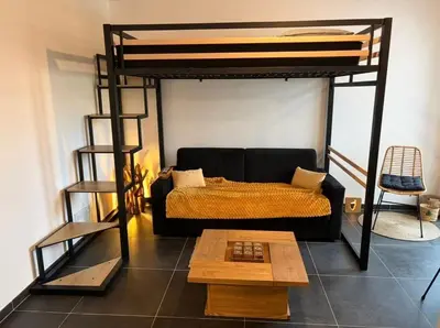 a living room with a bunk bed and a coffee table at L'Onda Serena - 4 couchages à 5 min de la plage in Ajaccio