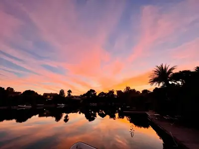 a sunset over a body of water with a palm tree at San Ciprianu-Lecci House, seaside, beach 2'' in Lecci