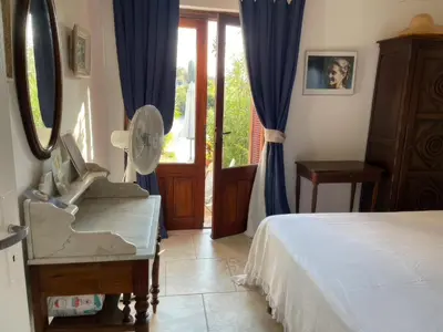 a bedroom with a bed and a mirror and a dresser at San Ciprianu-Lecci House, seaside, beach 2'' in Lecci