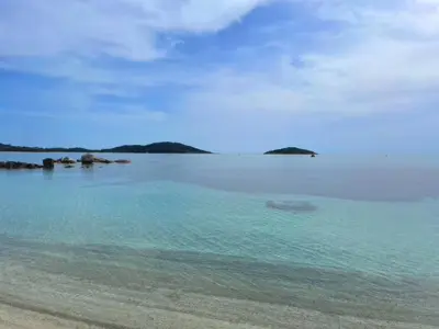 a beach with blue water and islands in the distance at San Ciprianu-Lecci House, seaside, beach 2'' in Lecci