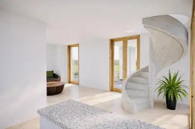 a living room with a concrete staircase and a potted plant at Villa Santa Giulia, vue mer, plage à pieds in Porto-Vecchio