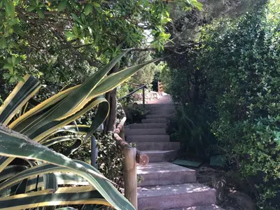 a stairway leading up to a set of stairs at Villa Santa Giulia, vue mer, plage à pieds in Porto-Vecchio