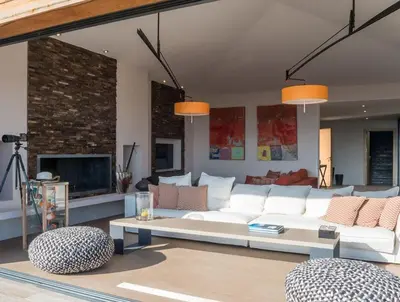 a living room with a white couch and a fireplace at Exclusive holiday home with pool in Porto-Vecchio