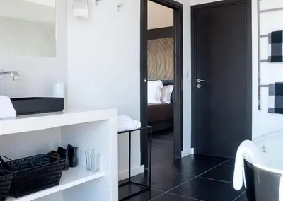 a bathroom with a sink and a toilet and a mirror at Exclusive holiday home with pool in Porto-Vecchio