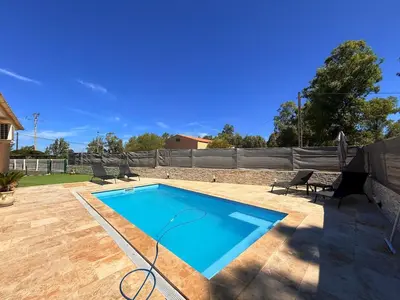 a swimming pool in a yard with chairs around it at Villa Paraìso, maison avec piscine route de Calenzana in Calenzana