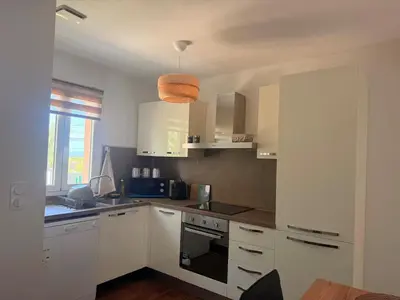 a kitchen with white cabinets and a sink at Villa Paraìso, maison avec piscine route de Calenzana in Calenzana