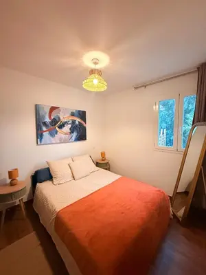 a bedroom with a bed and a painting on the wall at Villa Paraìso, maison avec piscine route de Calenzana in Calenzana
