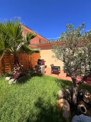a backyard with a grill and a bench and trees at Villa Paraìso, maison avec piscine route de Calenzana in Calenzana