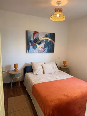 a bedroom with a bed and a painting on the wall at Villa Paraìso, maison avec piscine route de Calenzana in Calenzana