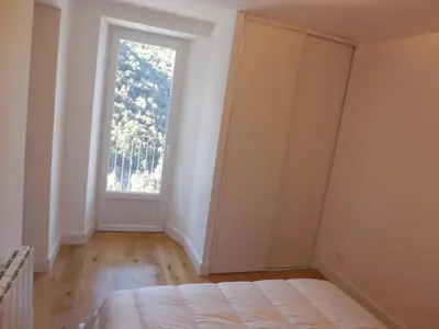 a room with a bed and a large window at Saint Christophe in Omessa