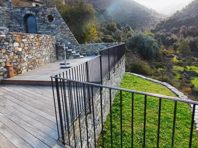 a wooden deck with a fence on top of a mountain at Saint Christophe in Omessa