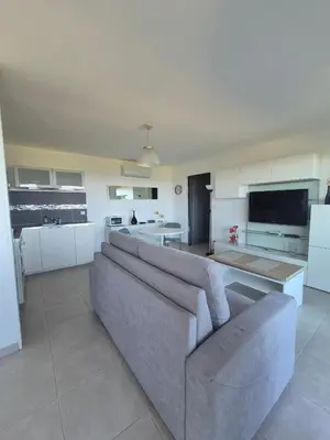 a kitchen with a table and a table and chairs at T2 vue mer in Chiatra