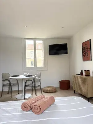 a white living room with a couch and a rug at Bienvenue chez vous ! in Ajaccio
