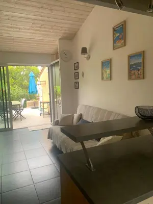 a kitchen with a refrigerator and a washer and dryer at Studio en bord de mer in Calcatoggio