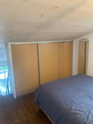 a bedroom with a bed and a wooden ceiling at Studio en bord de mer in Calcatoggio