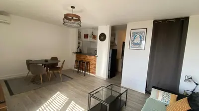 a living room with a couch and a table at T1B 41 m2 sea view Îles Sanguinaires beaches within walking distance in Ajaccio