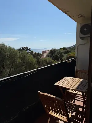 a view of the ocean from a roof of a house at T1B 41 m2 sea view Îles Sanguinaires beaches within walking distance in Ajaccio