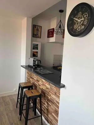 a kitchen with a counter and two stools in a room at T1B 41 m2 sea view Îles Sanguinaires beaches within walking distance in Ajaccio