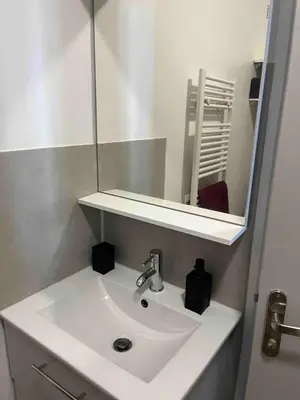 a white sink in a bathroom with a mirror at T1B 41 m2 sea view Îles Sanguinaires beaches within walking distance in Ajaccio