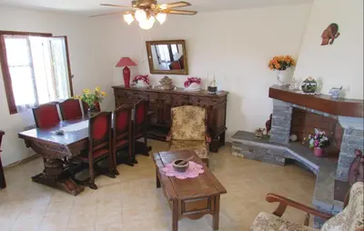 a living room with a table and a fireplace at Gorgeous Home In Valle Di Rostino in Valle-di-Rostino