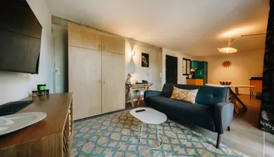 a living room with a couch and a table at Citta di Lume Suites & Lofts in Porto-Vecchio